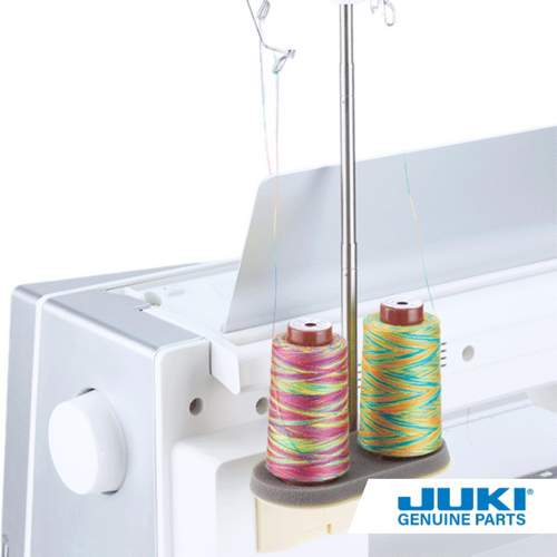 Double thread spool installed on the back of a Juki sewing machine holding two large spools of variegated thread.