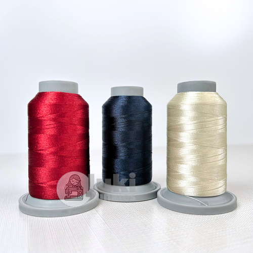 Shades of Cream, Navy, Ruby in Glide 40wt. mini spools of 1100yd spools