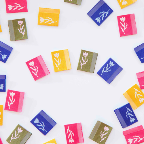 all 4 color ways of tiny floral labels laid on a table