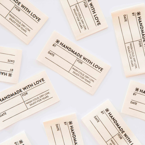 all four labels saying handmade with love scattered on table
