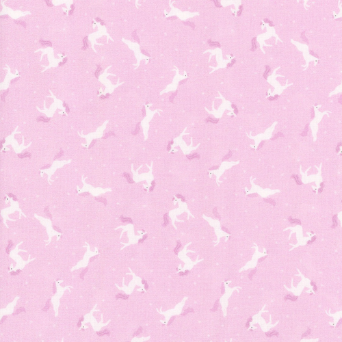 Close up of fabric which includes multiple ponies on a pink background
