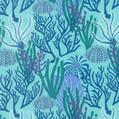Close up of fabric with various types of blue coral on a blue background