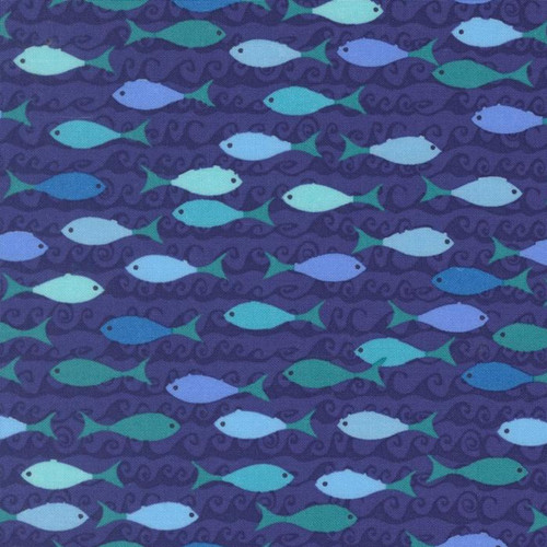 Close up of fabric with a variety of blue colored fish and dark blue waves on a blue background