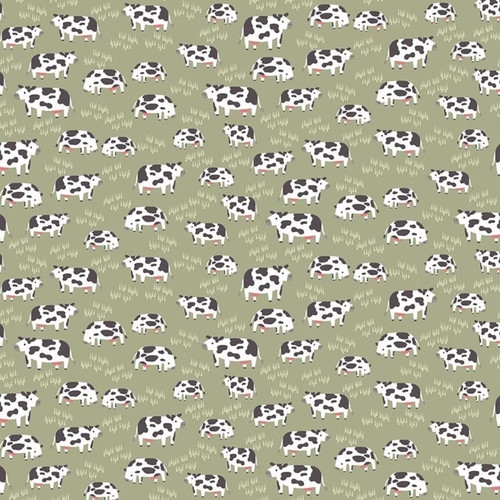 Close up of fabric with cows and light green grass on a green background