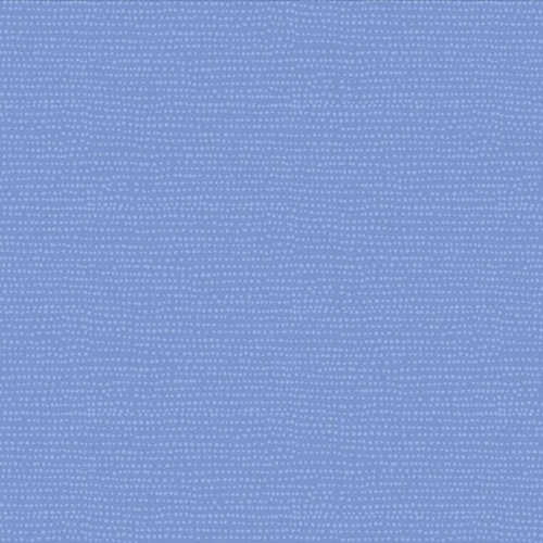 Close up of fabric which includes a blue background and small white dots