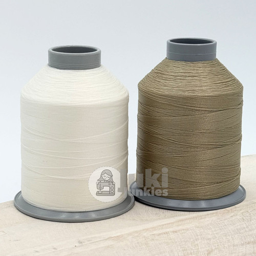 Close up of white and sand colored thread spools