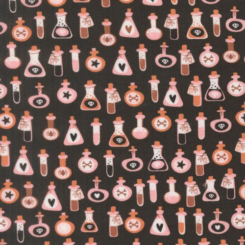 Close up of fabric with various potions and poison bottles on a black background