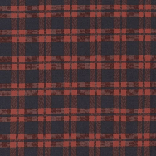Close up of fabric with a red and black plaid pattern