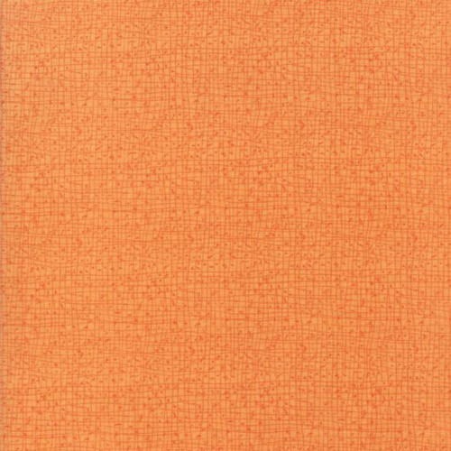 Close up of fabric with fine line details in orange on a lighter orange background
