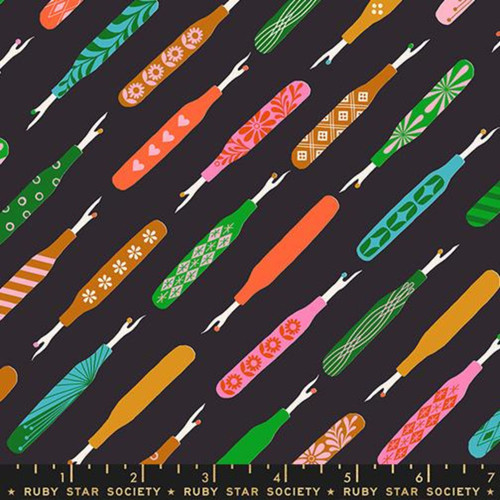 7inch by 7inch of fabric with colorful seam rippers with retro designs on them on a black background