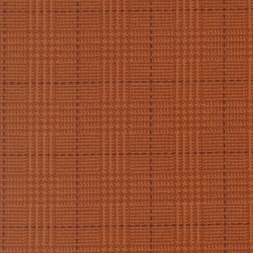 Close up of fabric with a plaid print in orange