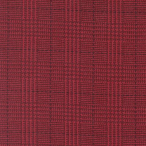 Close up of fabric with a plaid print in deep red