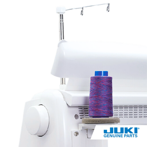 Single thread spool installed on the back of a Juki sewing machine holding a large spool of purple and blue thread.