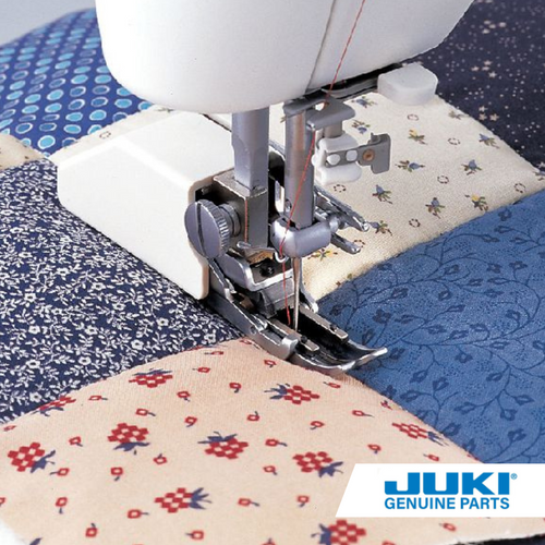 Juki walking foot (even feed) on a TL machine, stitching smoothly through layered fabric with upper feed dogs preventing shifting on stretch, vinyl, or quilted material