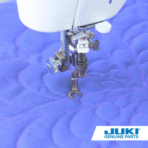 Juki front open toe quilting foot on a TL machine, free-motion quilting with clear view of the needle area and smooth stitching across thick seams.