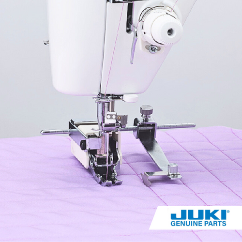 Juki quilt guide attached to walking foot on a TL machine, sewing evenly spaced parallel rows with adjustable positioning for left or right of the needle