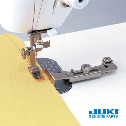 Juki swing gauge on a TL machine, guiding fabric edge for seam allowances up to 30 millimeters, with a short guide ideal for gentle curves and the ability to swing out of the way when not in use.