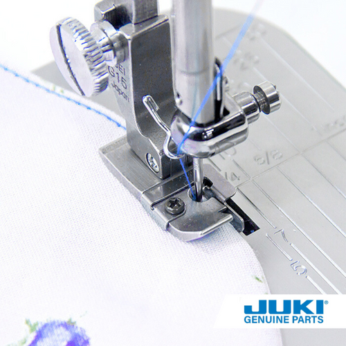 Juki spring guide hinged foot on a TL high shank machine, sewing a single lap stitch with a 1.5 millimeter width, using the thin spring guide to turn and stitch small curves on light to standard fabrics