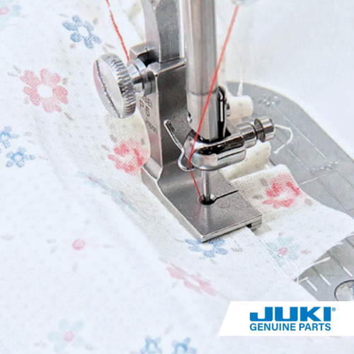 Juki top ply joining shirring foot on a TL high shank machine, stitching two fabric layers while gathering the lower ply to create consistent frills and tiered skirt ruffles.