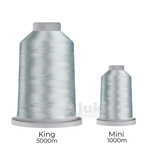 Close-up of two spools of Glide 40 weight polyester thread in Seagull: a large King spool (5,500 yards) and a smaller Mini spool (1,100 yards), shown side by side for size comparison, with a smooth texture and noticeable sheen.