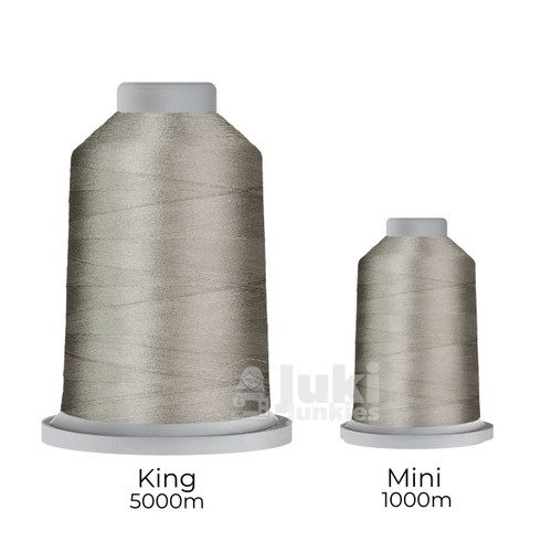 Close-up of two spools of Glide 40 weight polyester thread in Ash: a large King spool (5,500 yards) and a smaller Mini spool (1,100 yards), shown side by side for size comparison, with a smooth texture and noticeable sheen.