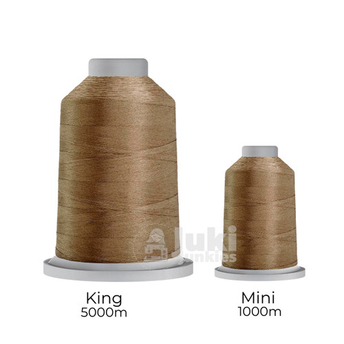 Close-up of two spools of Glide 40 weight polyester thread in Light Tan: a large King spool (5,500 yards) and a smaller Mini spool (1,100 yards), shown side by side for size comparison, with a smooth texture and noticeable sheen.