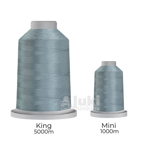 Close-up of two spools of Glide 40 weight polyester thread in Graphite: a large King spool (5,500 yards) and a smaller Mini spool (1,100 yards), shown side by side for size comparison, with a smooth texture and noticeable sheen.