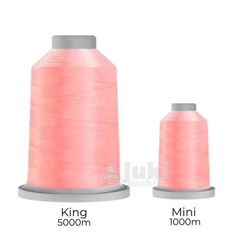 Close-up of two spools of Glide 40 weight polyester thread in Pink Lemonade: a large King spool (5,500 yards) and a smaller Mini spool (1,100 yards), shown side by side for size comparison, with a smooth texture and noticeable sheen.