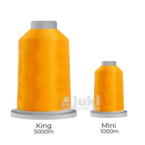 Close-up of two spools of Glide 40 weight polyester thread in Mango: a large King spool (5,500 yards) and a smaller Mini spool (1,100 yards), shown side by side for size comparison, with a smooth texture and noticeable sheen.