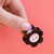 Button Hair clip in hand showing details