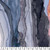12inch by 12inch of fabric with an abstract watercolor design with shades of dark blue, orange, white, and light blue