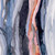 Close up of fabric with an abstract watercolor design with shades of dark blue, orange, white, and light blue
