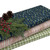3 bolts of fabric from the Wreck the Halls collection with leaves, berries and pinecones