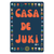 Blue sticker with Orange letters saying Casa De Juki. Flower border