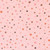 Close up of fabric with black, pink, red, and orange stars on a pink colored background
