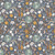 Close up of fabric with giraffes, elephants, rainbows, flowers, butterflies and the earth on a dark blue background
