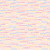 Close up of fabric with a dotted line pattern in rainbow on a cream background
