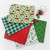 5 swatches of fabric from the Catmas Carols collection with thread 