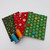 fabric swatches from the Little Grinch collection with red, yellow, green, blue, and orange spools of thread