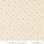 7inch by 7inch of fabric with small polka dots in green, yellow, blue, and black on a cream colored background
