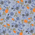 Close up of fabric with black and blue roses and orange pumpkins with green leaves on a light blue background