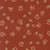 Close up of fabric with autumn leaves falling on a dark red background