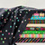 Bolts of fabric from the 1 800 Notion collection, fabric patterns includes buttons, chevron stripes, thimbles, scissors, seam rippers, abstract patterns