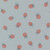 Close up of fabric with red berries with muted leaves on a muted blue background