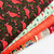 4 bolts of fabric with red cardinals, wreaths, holly, golds dots, carols, and carolers