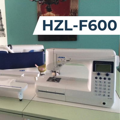 A Juki HZL-F600 sewing machine positioned next to an auxiliary table, not connected.