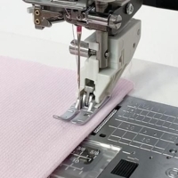 close-up of the professional grade AcuFeed dual feed foot in action