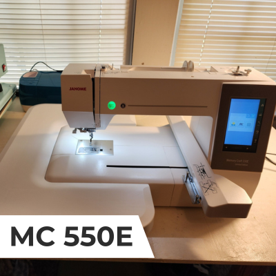 A top down view of Janome Memory Craft 550e embroidery machine with extension table.