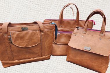 Three faux leather handbags sewn with the Juki TL-18QVP, showcasing smooth seams