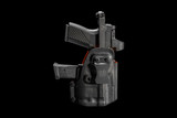 RXM Reaper chassis seated inside the custom molded holster featuring secure firearm retention, integrated magazine storage compatibility, and a compact carry-ready design engineered for everyday